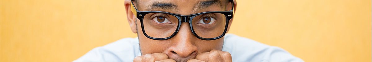 A man with glasses looking nervous